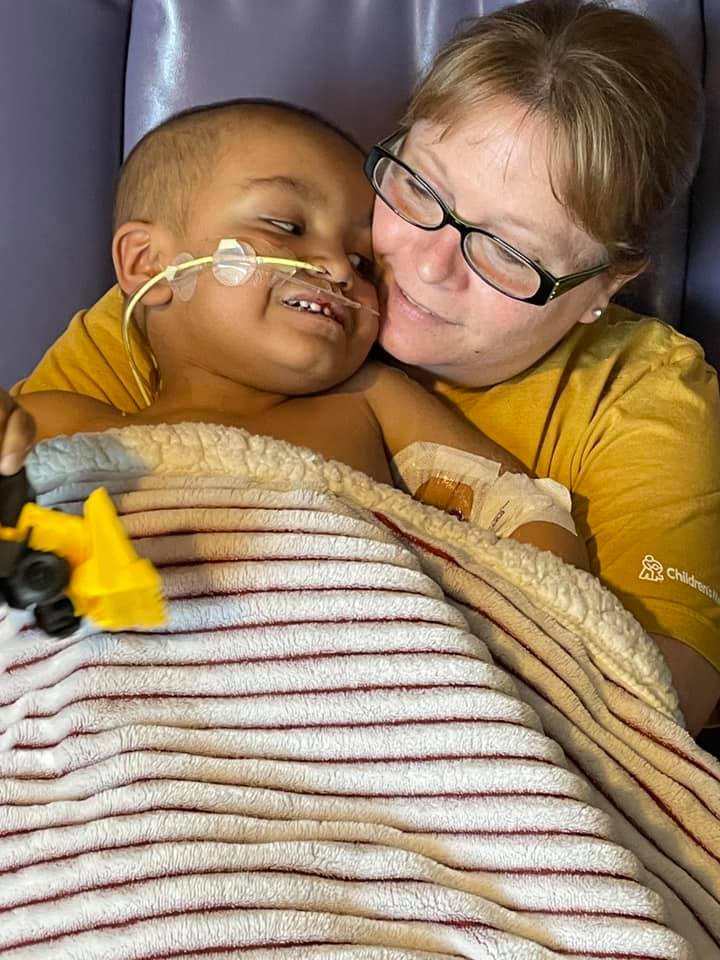 Greyson cuddling with his mom
