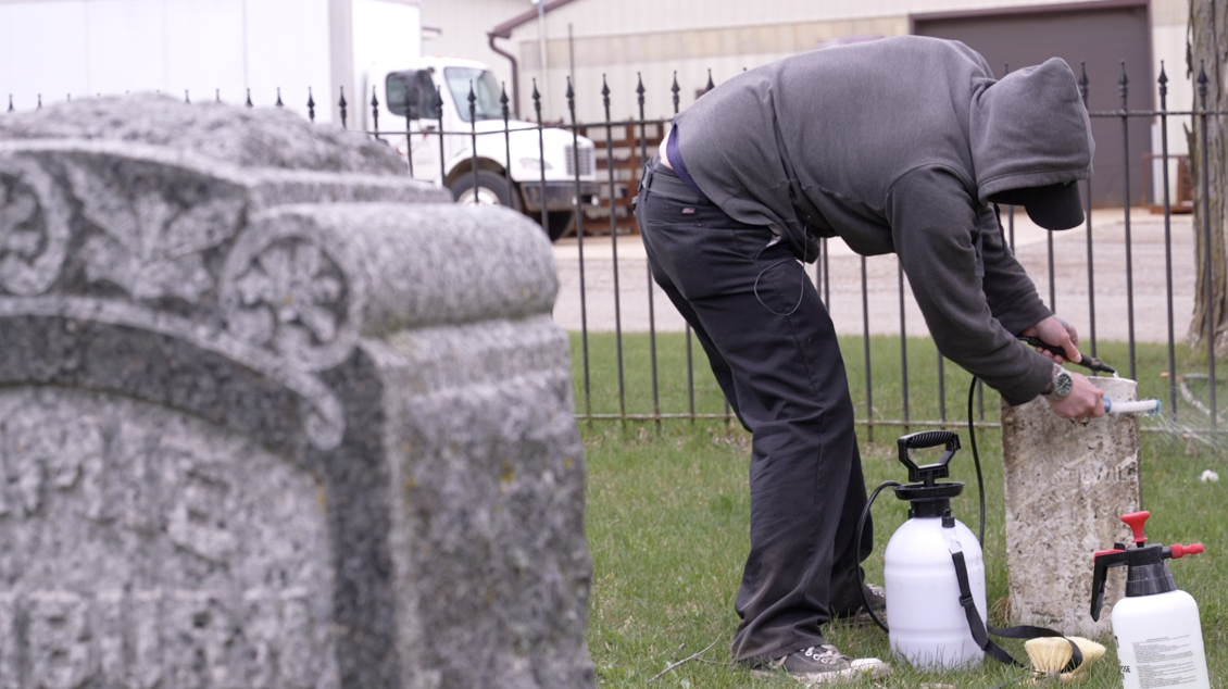 Cleaning gravestones in Mt. Rest Cemetery in St. Johns