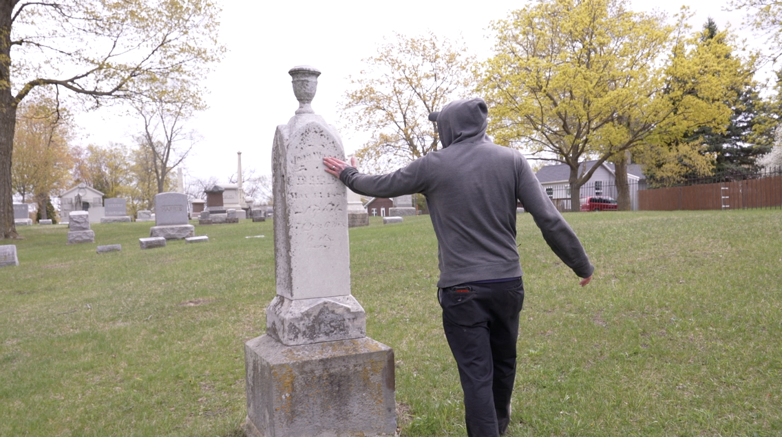 Cleaning gravestones in Mt. Rest Cemetery in St. Johns
