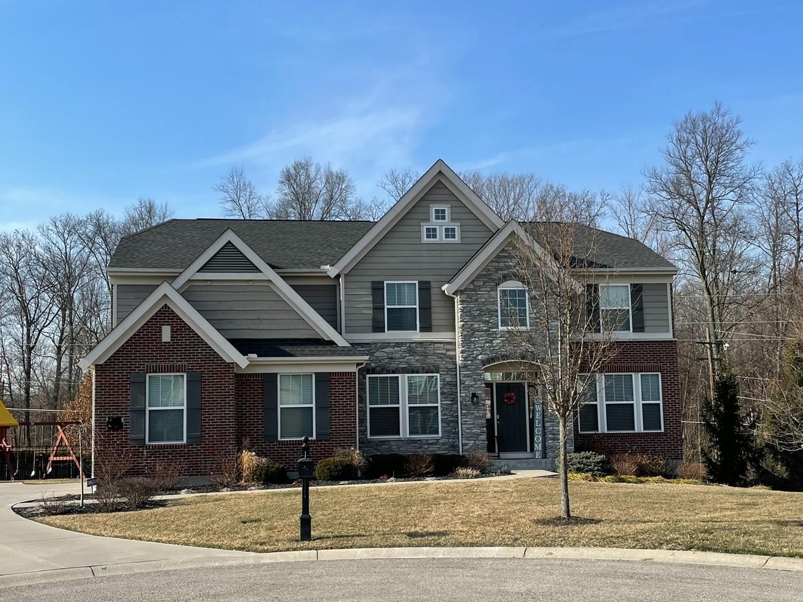 This photo shows the Parkers' home in Loveland. It's a large, two-story house with red brick, stone and siding.