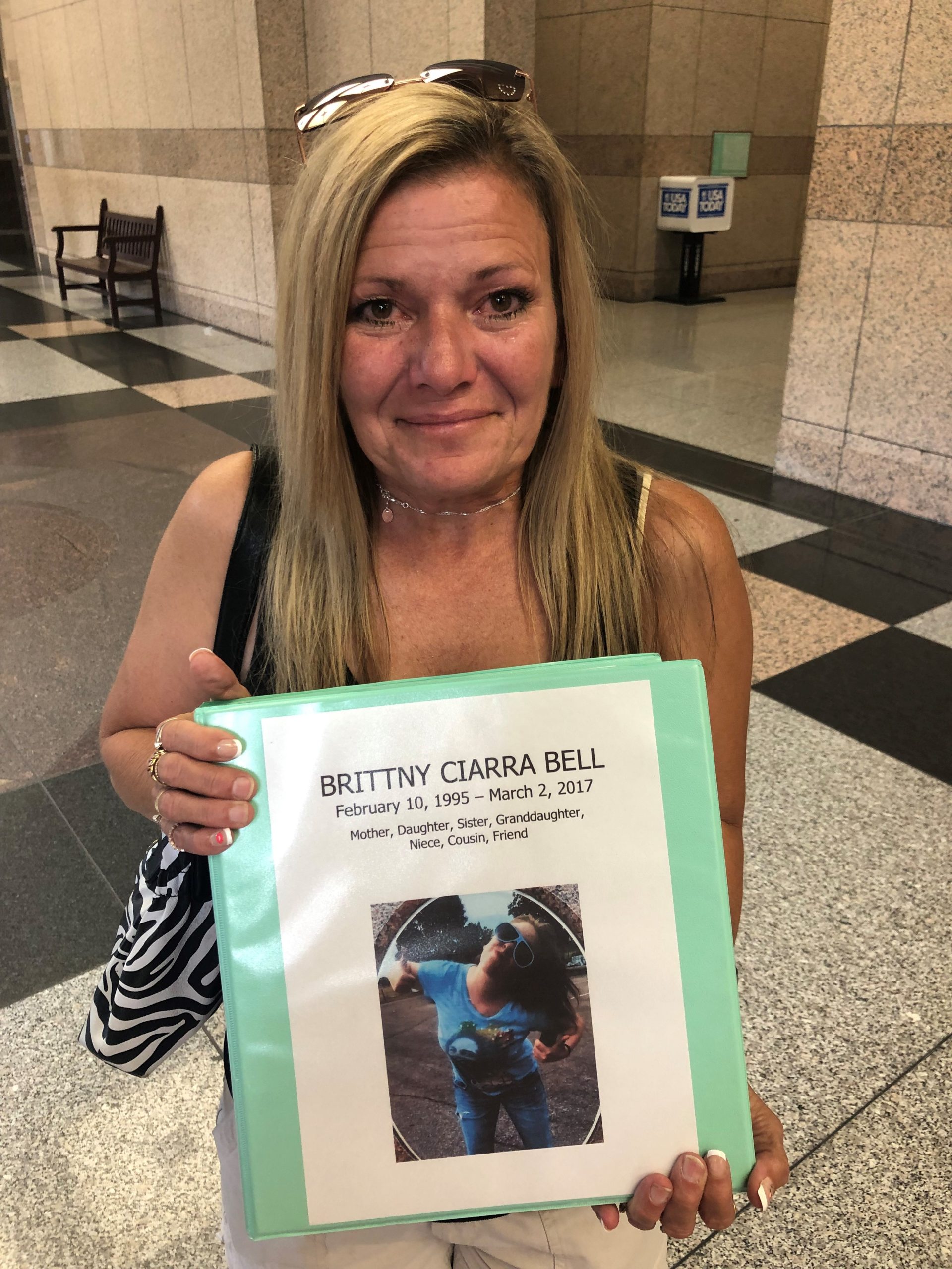 Donna Bell clutches a binder outlining evidence surrounding the death of her daughter Brittny Bell, who was found dead in her Kokomo home at the age of 22 in 2017.