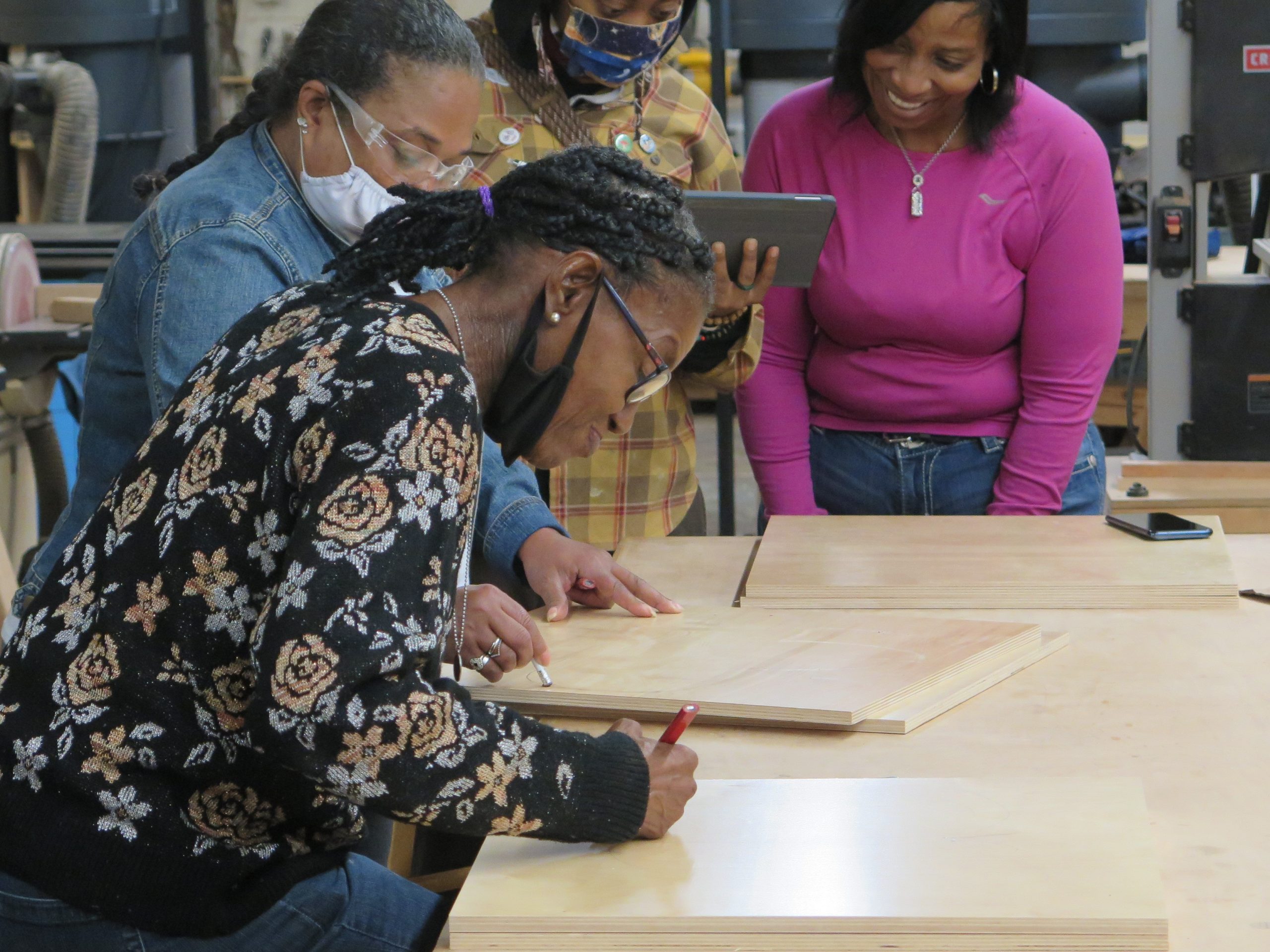 Johnnie Mae Gutter draws an angel design on a piece of wood during a class on Sept. 22, 2021.