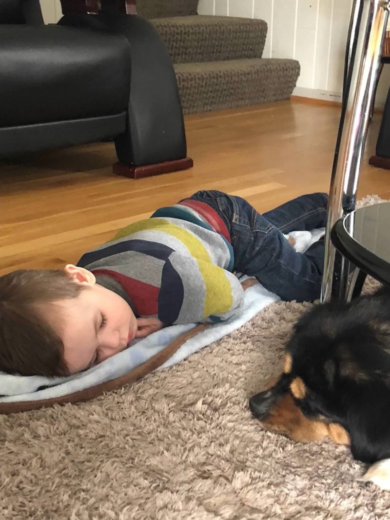 Cole sleeping alongside family pet.jpg