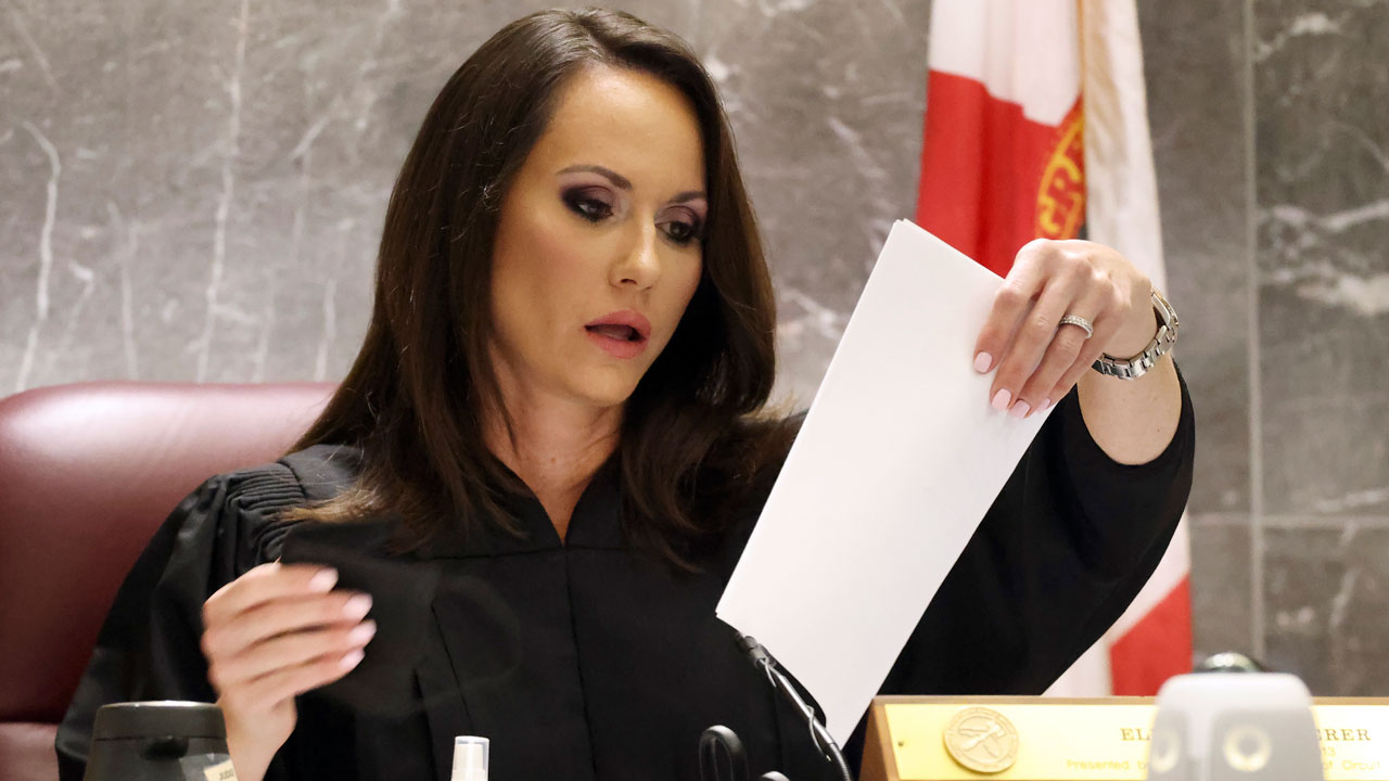 Judge Elizabeth Scherer looks at paperwork, at the Broward County Courthouse in Fort Lauderdale, Fla. on Wednesday, Oct. 20, 2021