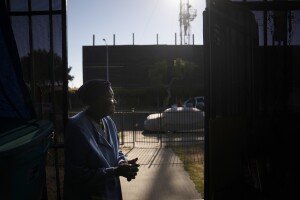 FILE - Q.C. Kelker, 83, stands at her home across the street from the Jefferson oil drill site Thursday, June 24, 2021, in Los Angeles.