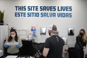 A sign on the wall reads "This site save lives" in Spanish and English at an overdose prevention center at OnPoint NYC in New York, N.Y., Friday, Feb. 18, 2022.