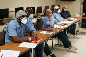 Incarcerated students listen to a discussion during a Mount Tamalpais College English class called Cosmopolitan Fictions at San Quentin State Prison on April 12, 2022, in San Quentin, Calif. The community college, the first in California with a campus inside a prison, is the latest addition to San Quentin's numerous rehabilitation programs that have made it a desired destination for inmates throughout the state. (AP Photo/Eric Risberg)