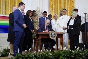President Joe Biden signs an executive order at an event to celebrate Pride Month in the East Room of the White House, Wednesday, June 15, 2022, in Washington. (AP Photo/Patrick Semansky)
