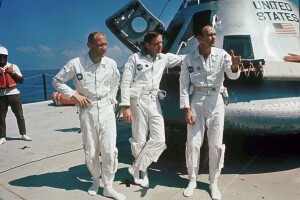 FILE - In this May 24, 1969 file photo, Apollo 11 astronauts from left, Col. Edwin "Buzz" Aldrin, lunar module pilot; Neil Armstrong, flight commander; and Lt. Michael Collins, command module pilot, stand on the deck of the NASA Motor Vessel Retriever prior to participating in water egress training. In the background is a mockup of the command module. Collins, who piloted the ship from which Armstrong and Aldrin left to make their historic first steps on the moon in 1969, died Wednesday, April 28, 2021, of cancer, his family said. He was 90. (AP Photo/File)