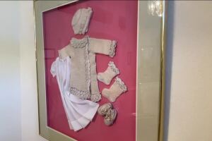 Yvonne framed baby clothes
