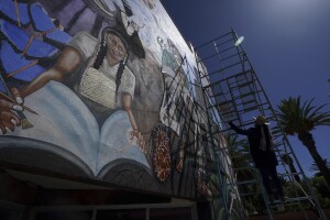 Mexican mural artist Janet Calderon paints on the facade of a municipal building in San Salvador, Mexico, Saturday, July 30, 2022. Calderon is part of a group of artists helping to revive muralism, a movement that put Mexico at the vanguard of art a century ago.(AP Photo/Fernando Llano)