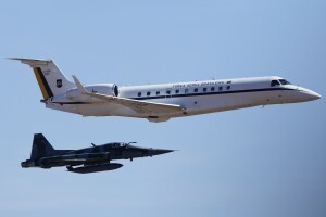 A Brazilian Air Force plane is escorted by a fighter jet as it carries the heart of Brazill's former emperor Dom Pedro I and prepares to land at an air base in Brasilia, Brazil, Monday, Aug. 22, 2022. The heart arrived for display during the celebrations of Brazil's bicentennial on Sept. 7. (AP Photo/Eraldo Peres)