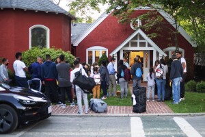 Immigrants flown to Martha's Vineyard stand outside St. Andrews Episcopal Church, Sept. 14, 2022
