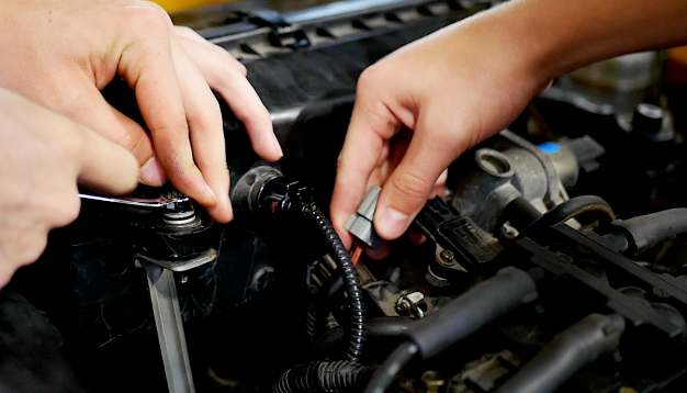 Students working on cars 