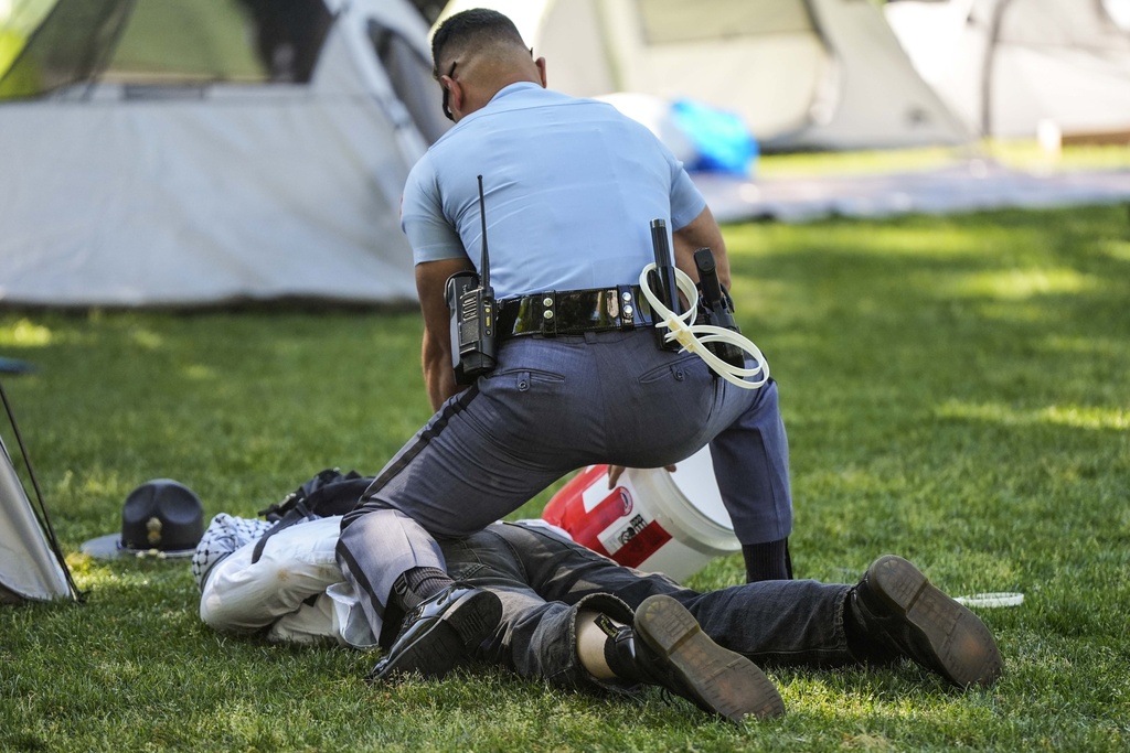 A Georgia State Patrol officer detains a protester at Emory University.
