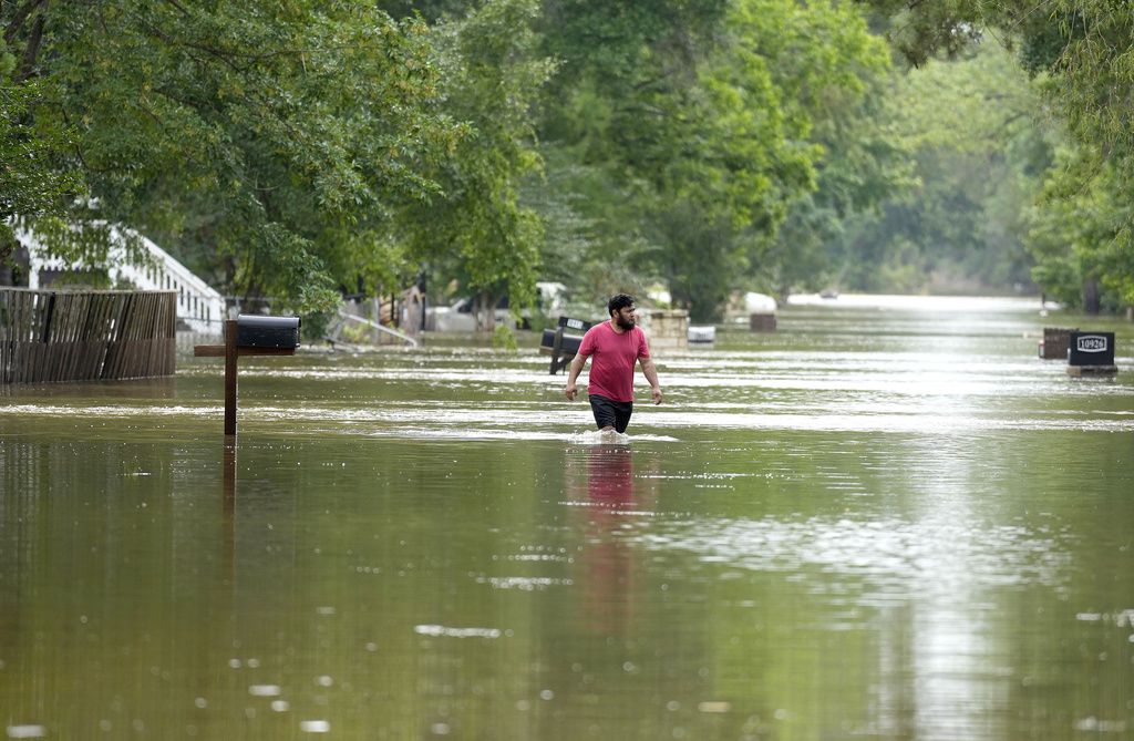 A man walks through floodwaters