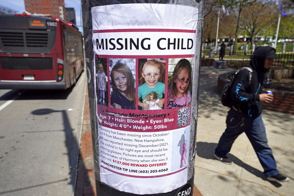 A man walks past the "missing child" poster for Harmony Montgomery.