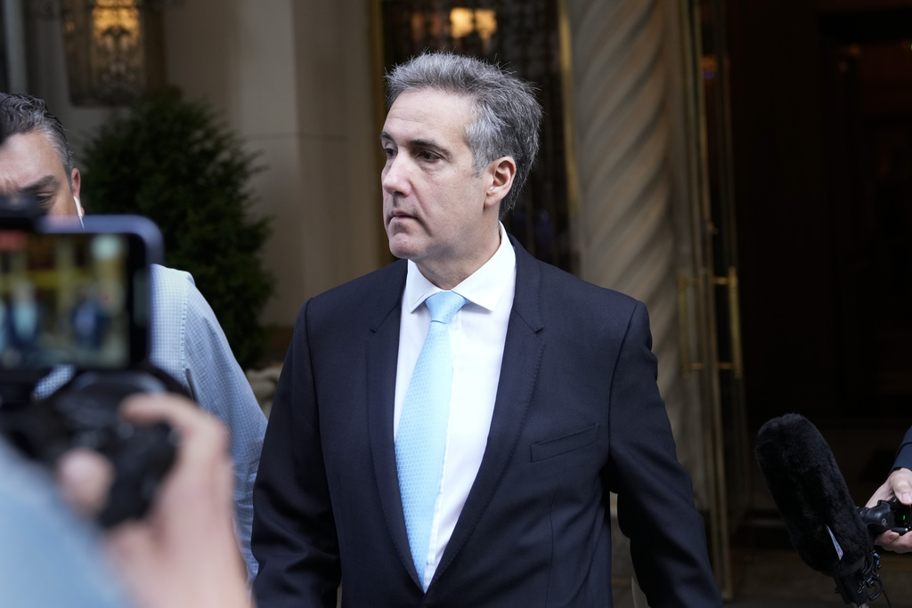 Michael Cohen is surrounded by media as he leaves his apartment building in New York.