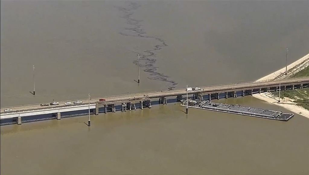 Oil spills into the surrounding waters after a barge hit a bridge in Galveston, Texas.