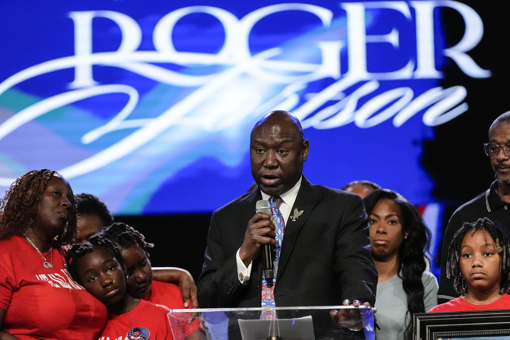 Trial lawyer Benjamin Crump speaks as the family of slain airman Roger Fortson look on during a news conference.