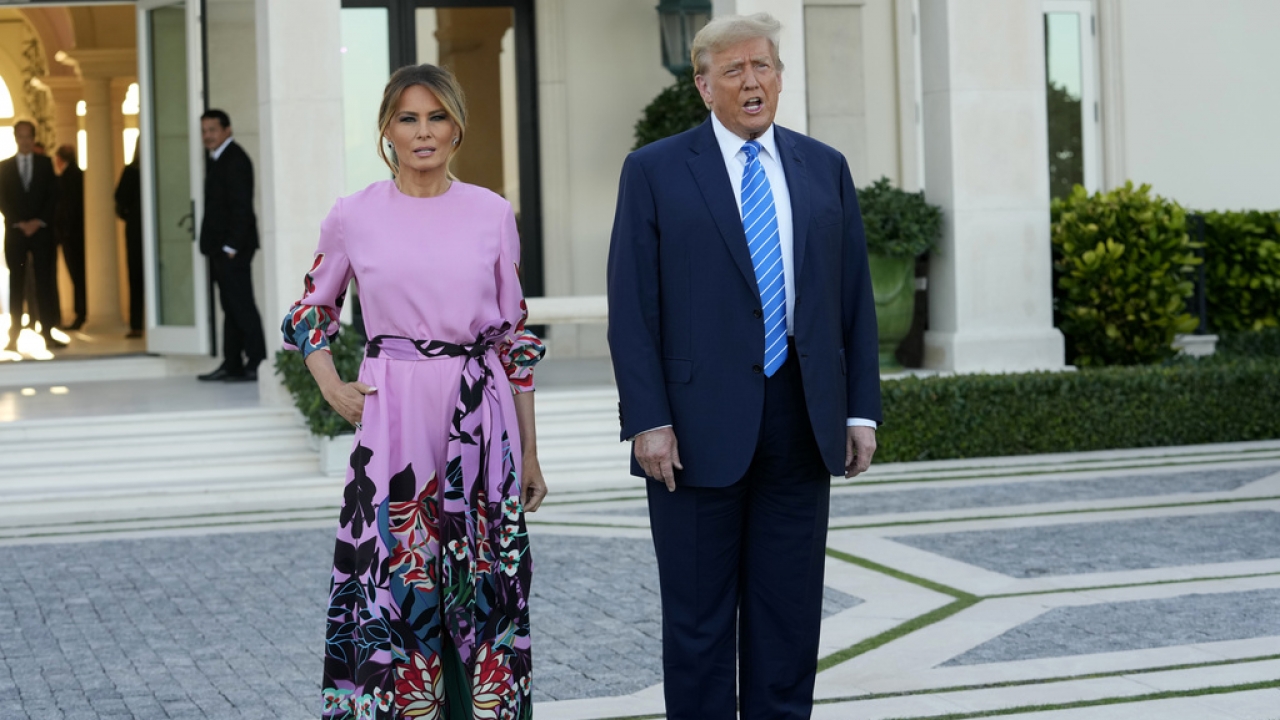Former President Donald Trump, right, stands with Melania Trump, left, as they arrive for a GOP fundraiser, Saturday.