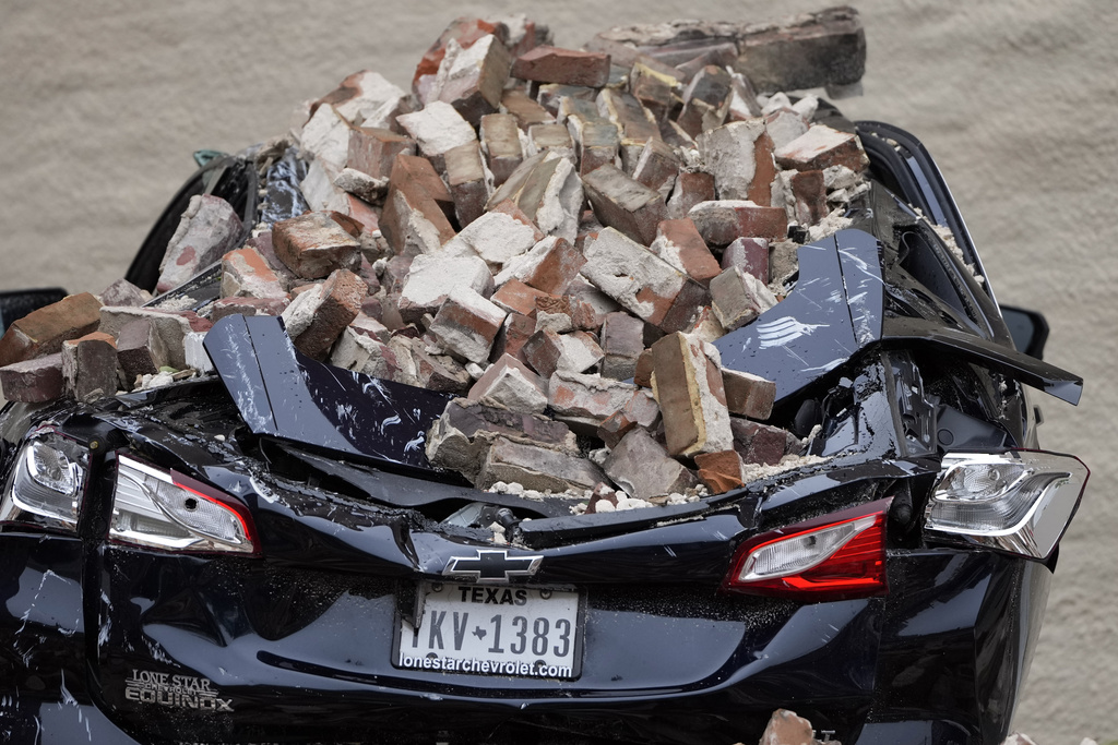 A car damaged by bricks which fell from a building wall during high winds in Houston