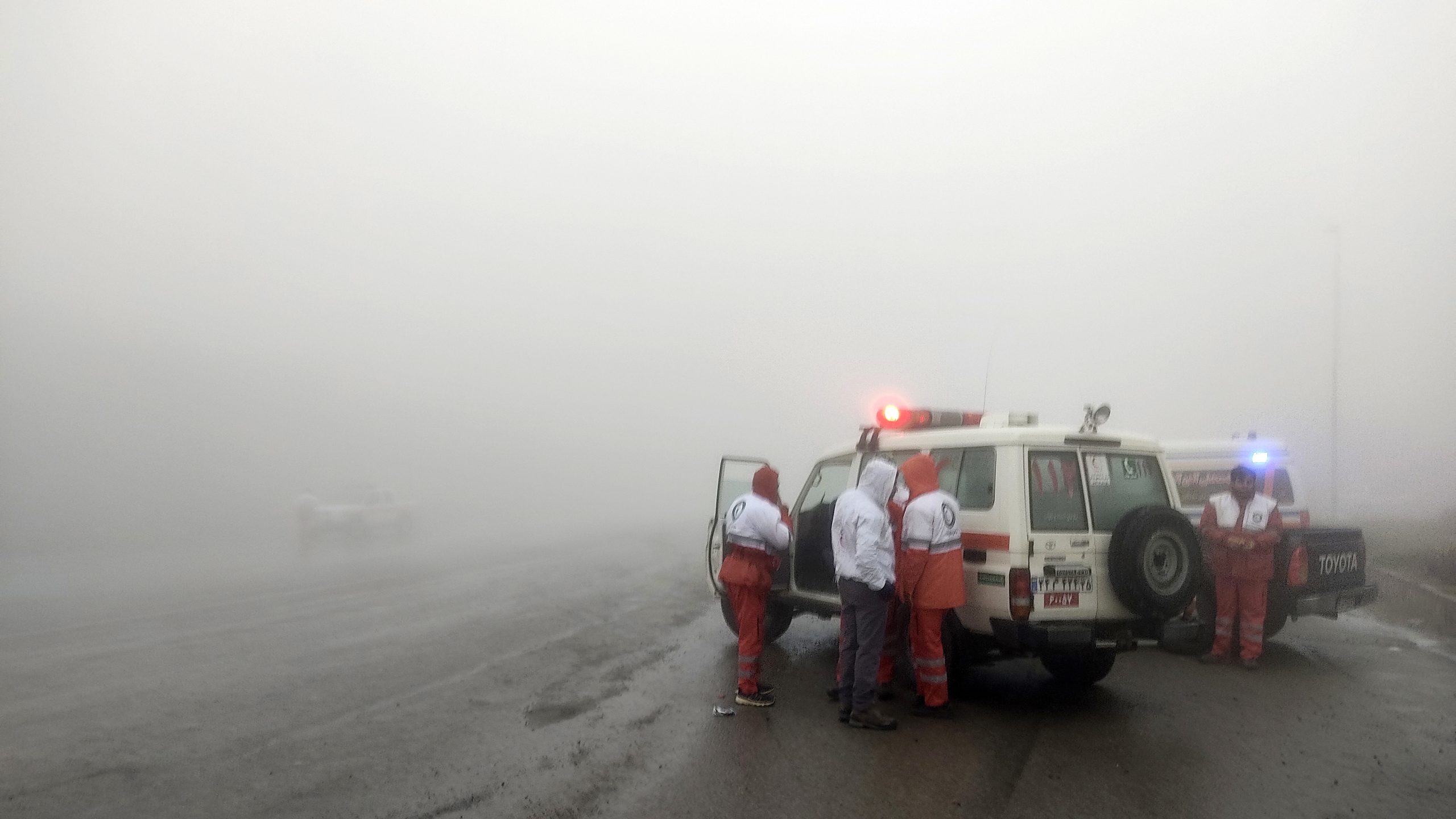 Rescue teams are seen in dense fog near the site of the helicopter crash that killed Iranian President Ebrahim Raisi in Varzaghan in northwestern Iran.