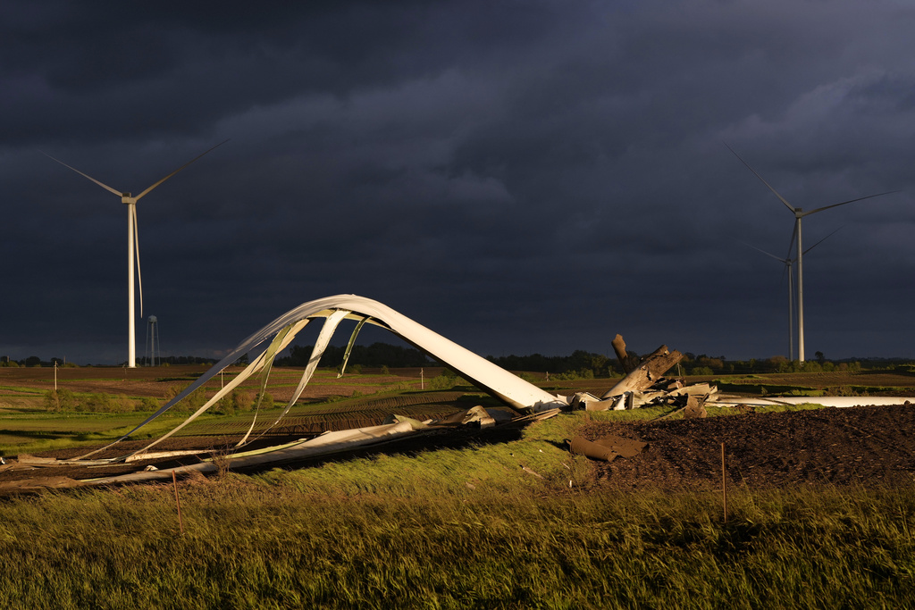 The remains of a tornado-damaged wind turbine touch the ground.