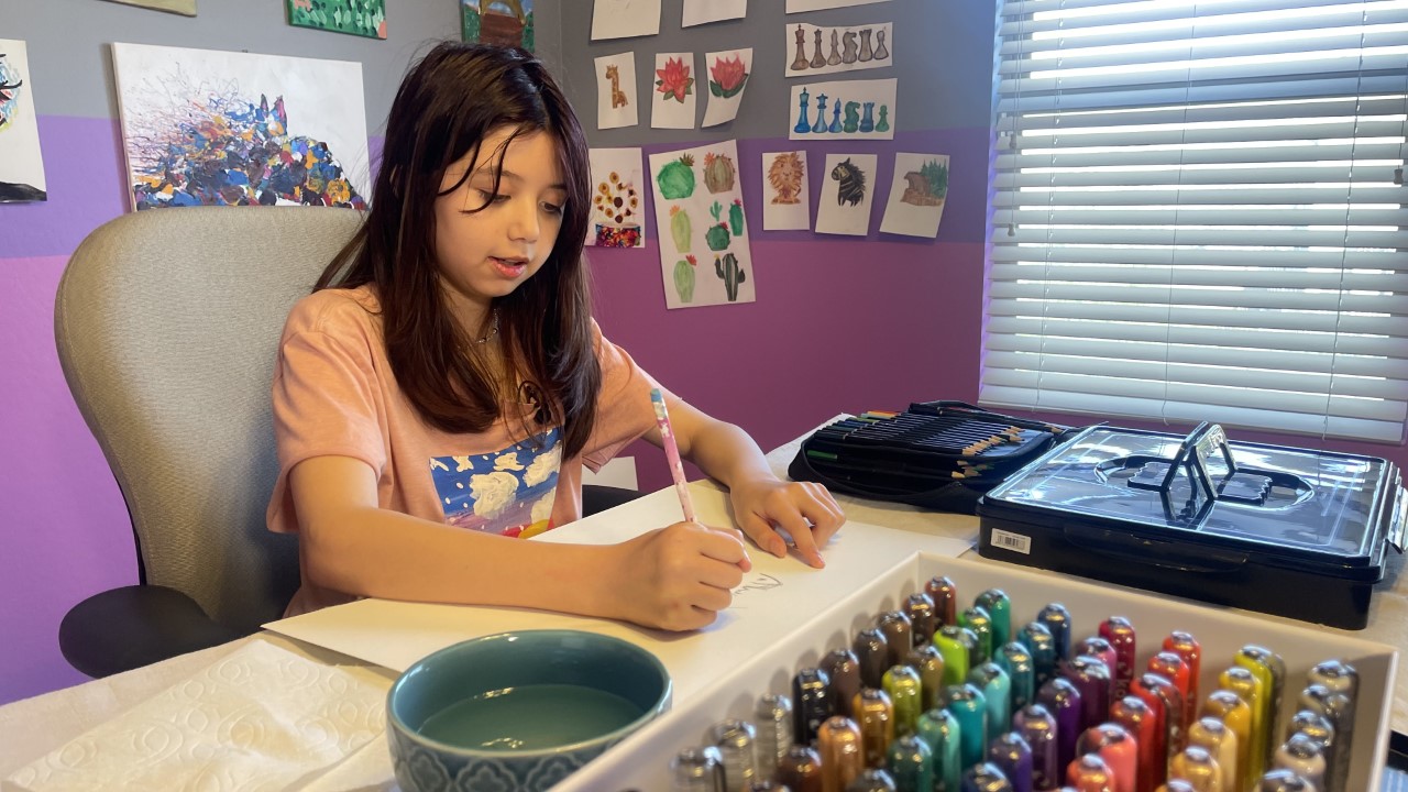 11-year-old Audrina Nguyen-Oerzen works on her designs.