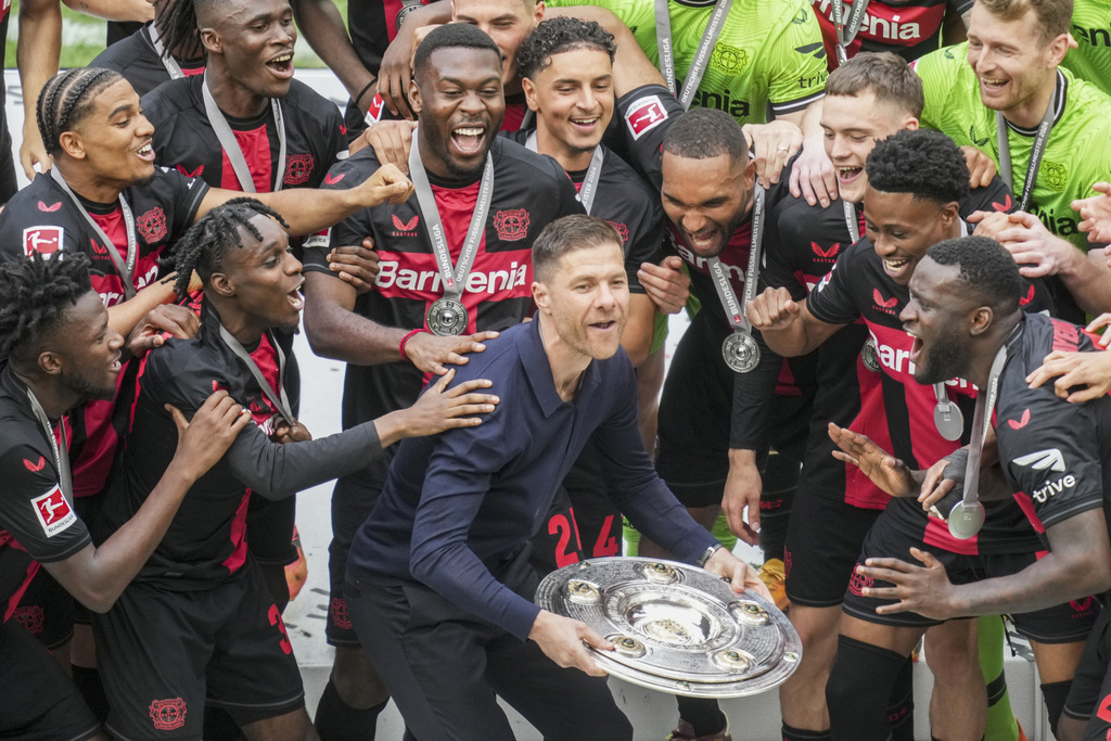 Leverkusen's head coach Xabi Alonso celebrates with the trophy as his team won the German Bundesliga