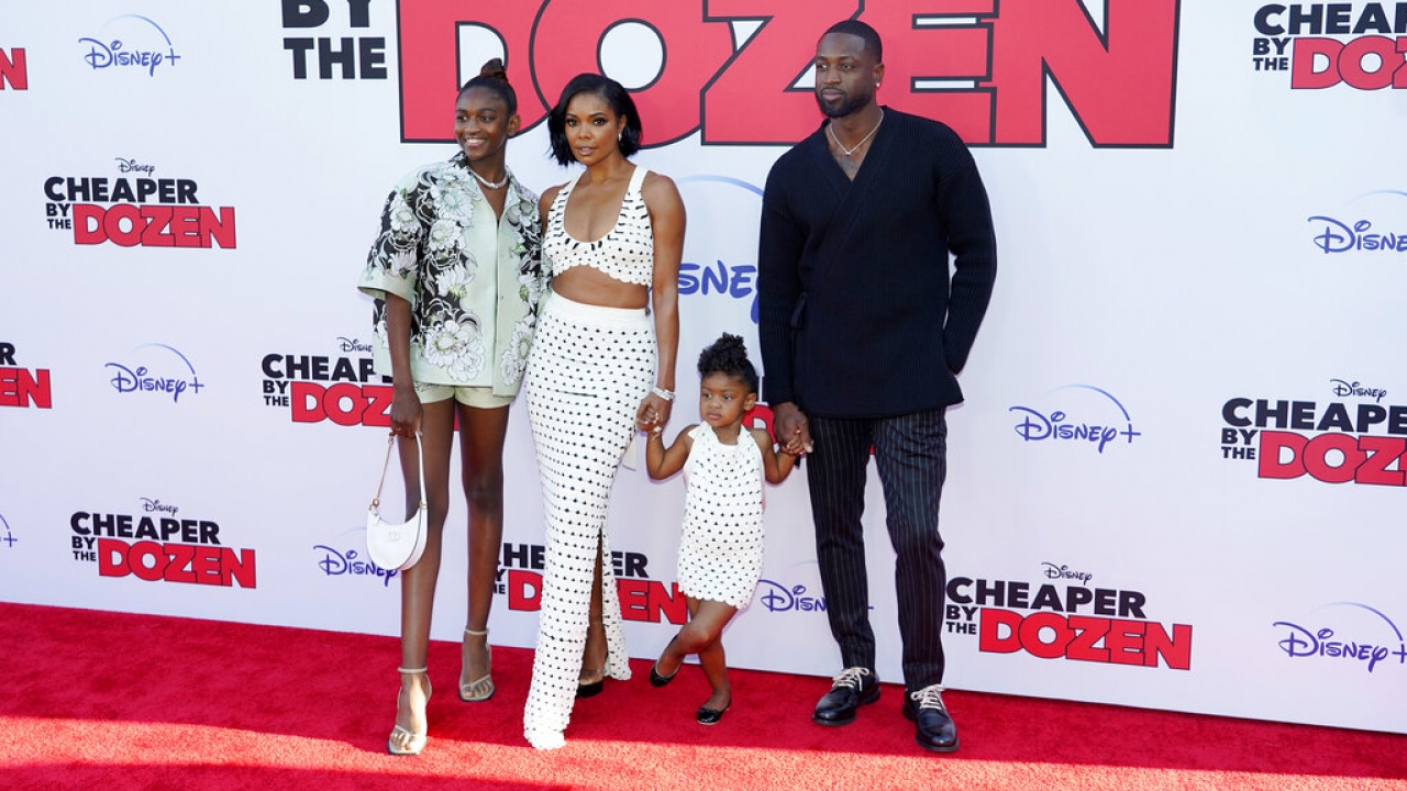 Dwyane Wade and Gabrielle Union with their daughters at a premiere.