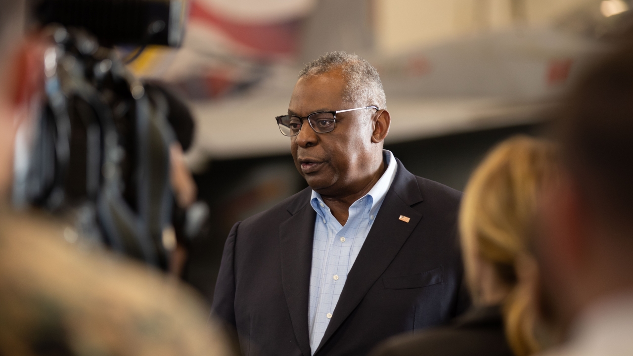 Secretary of Defense Lloyd Austin speaks with reporters in the hangar bay of USS Gerald R. Ford (CVN 78) in December 2023.