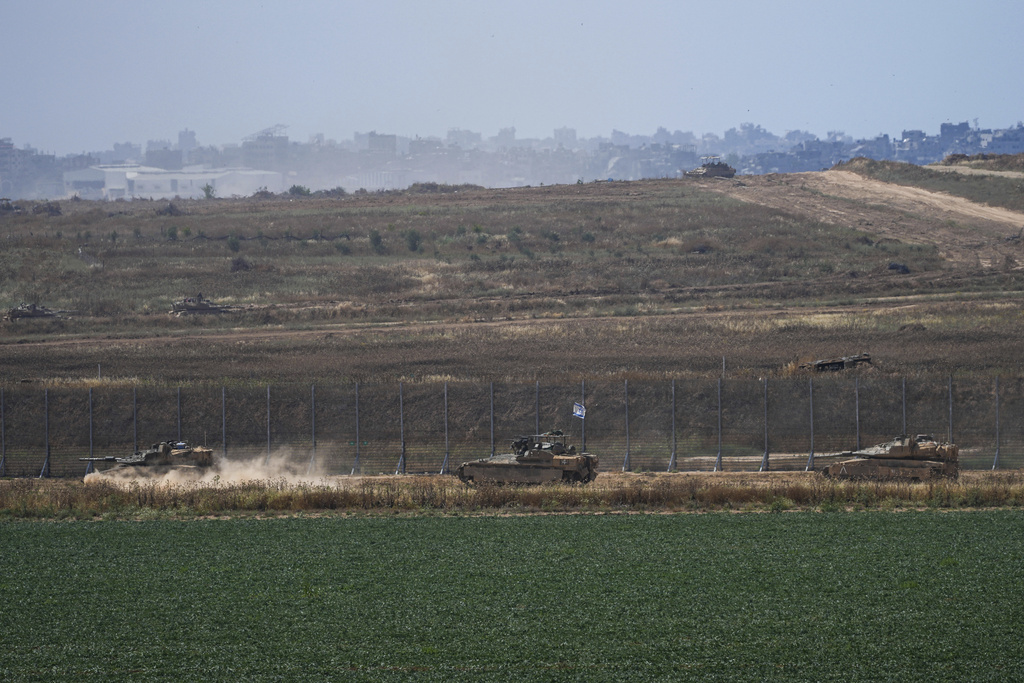 Israeli tanks move near the Israeli-Gaza border.