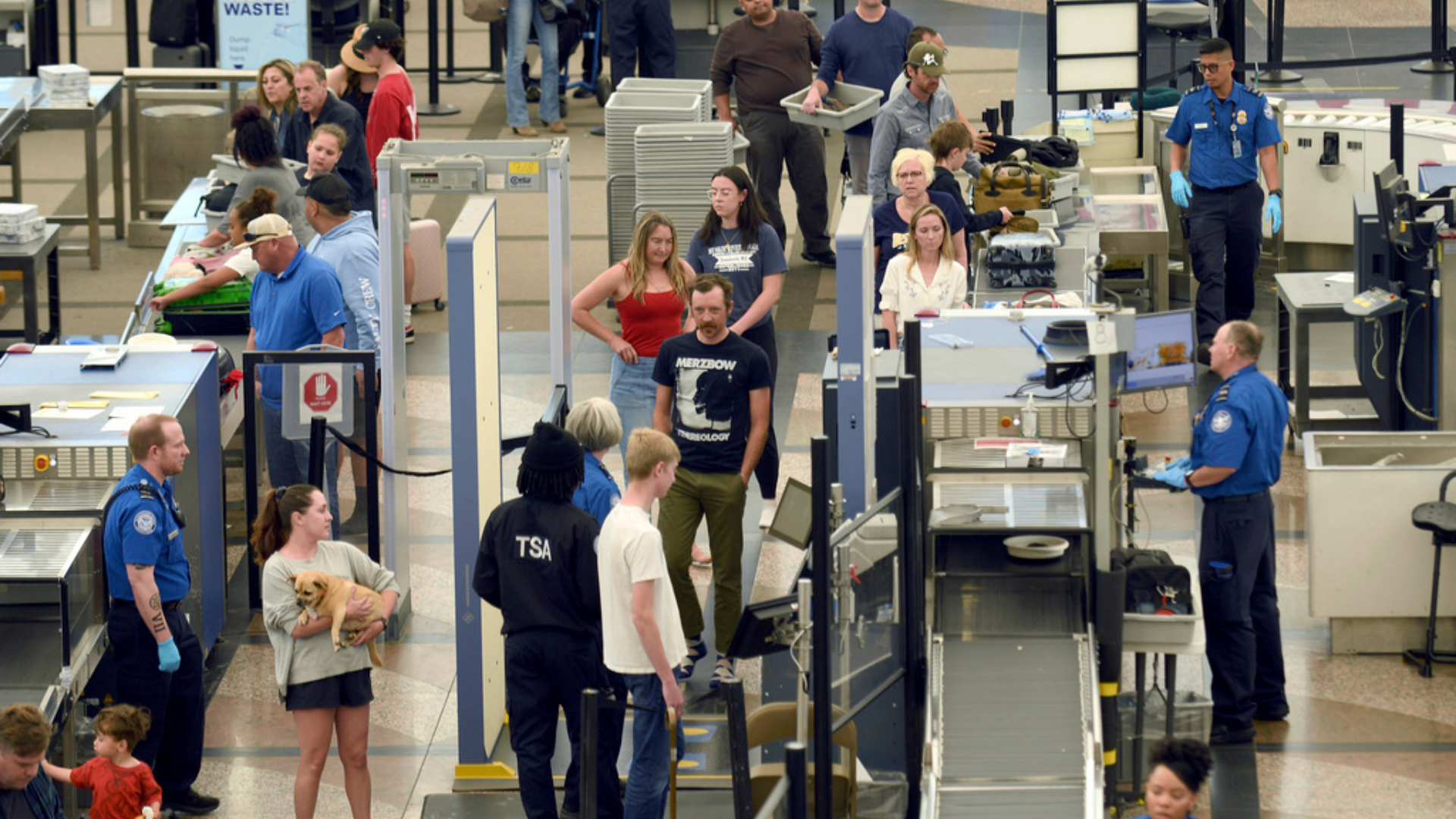 Travelers make their way through security at Denver International Airport
