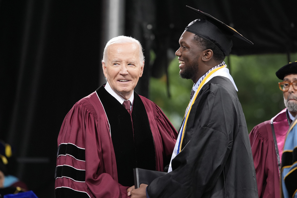 President Joe Biden, left, stands with valedictorian DeAngelo Jeremiah Fletcher at the Morehouse College commencement.