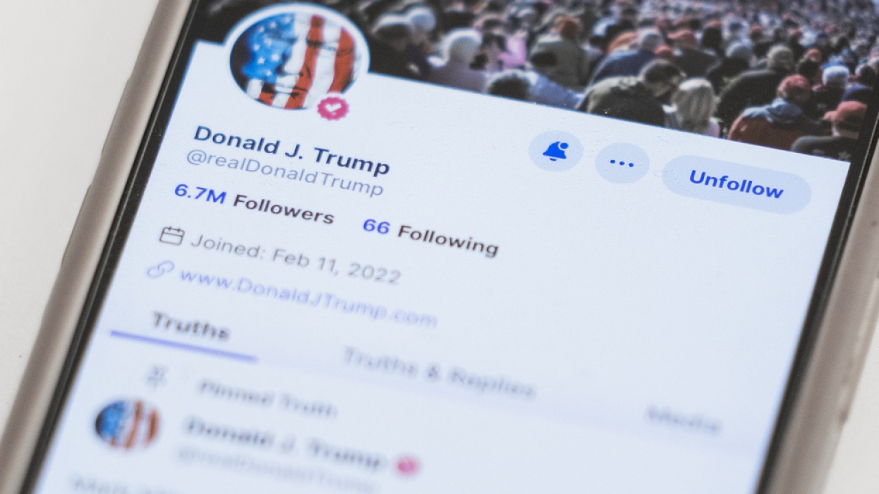 The Truth Social account for former President Donald Trump is seen on a mobile device