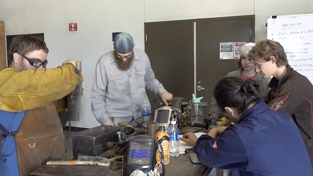 A group of students learning to weld