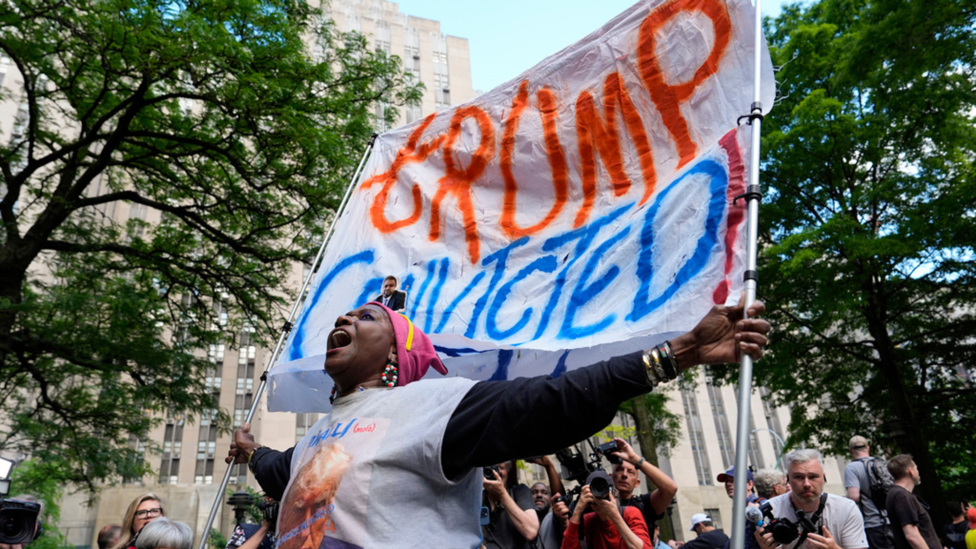 A demonstrator reacts to the guilty verdict announced against former President Donald Trump outside Manhattan Criminal Court