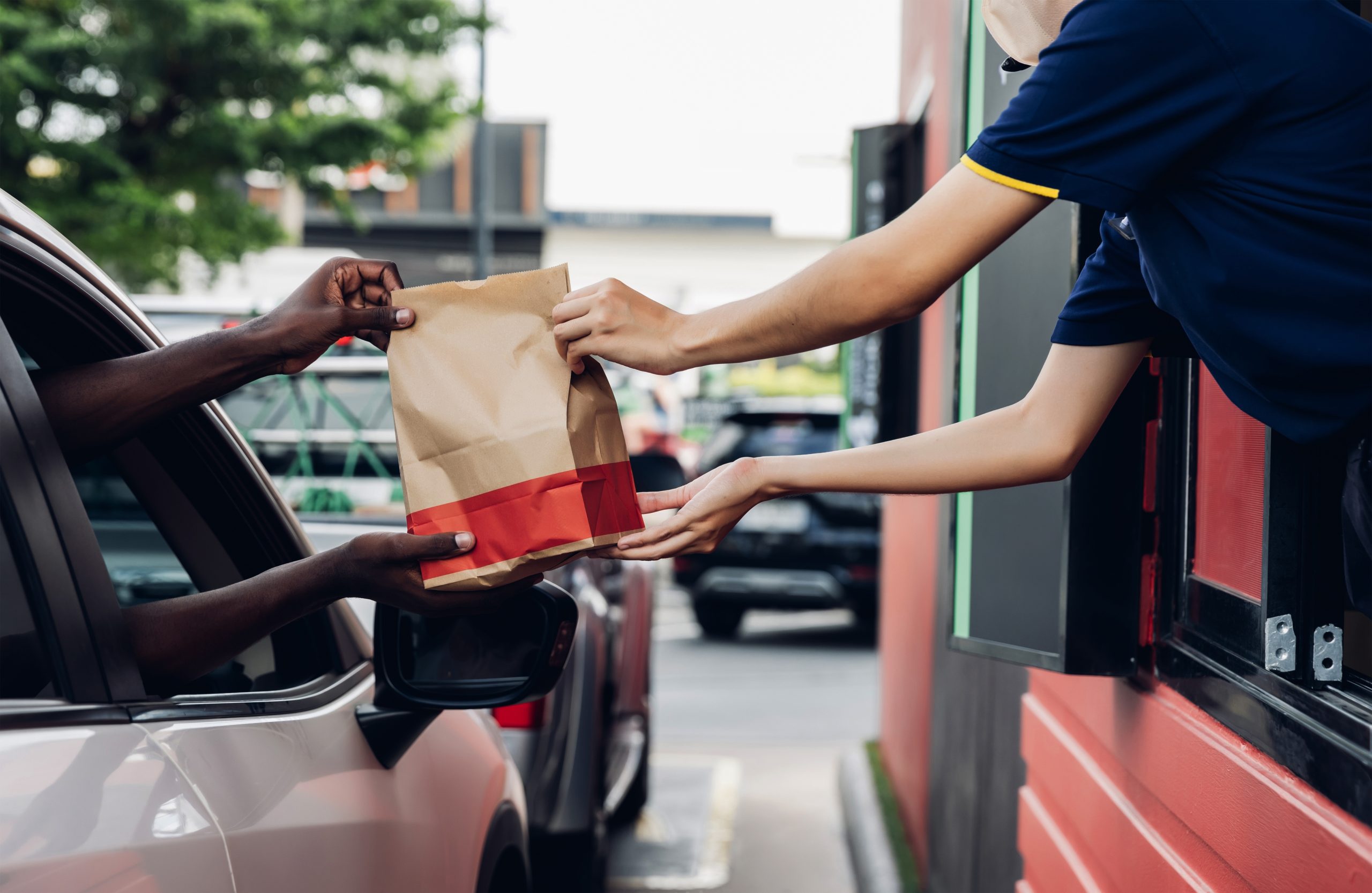 Fast food is served at a drive-thru.