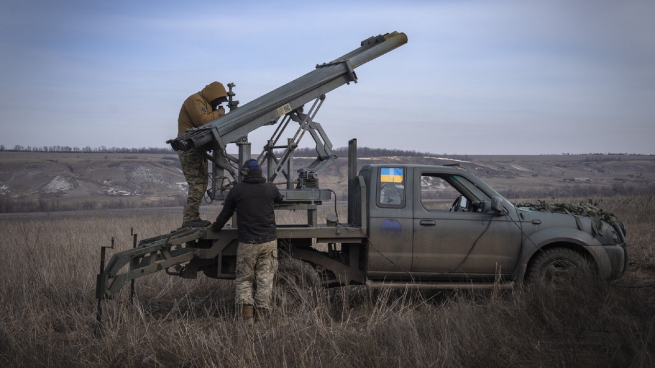 Ukrainian soldiers prepare to fire a multiple launch rocket system.