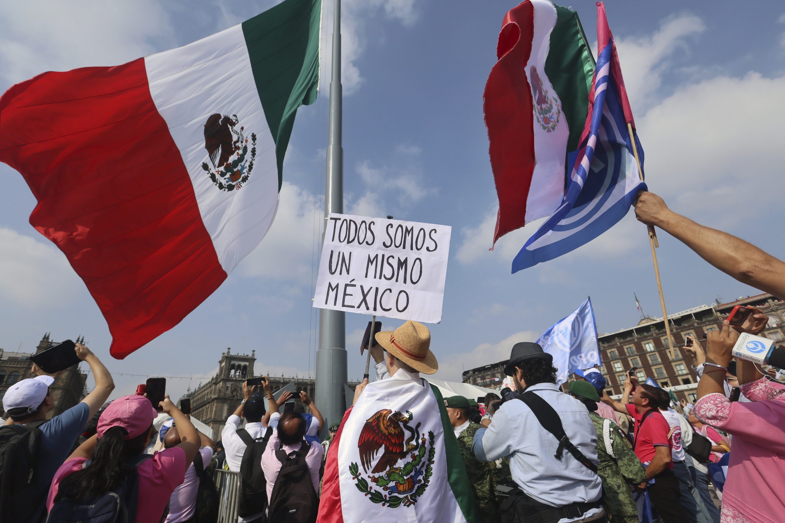 A person holds a sign that reads "We are all the same Mexico" at an opposition rally called to encourage voting ahead of the June 2 presidential elections.