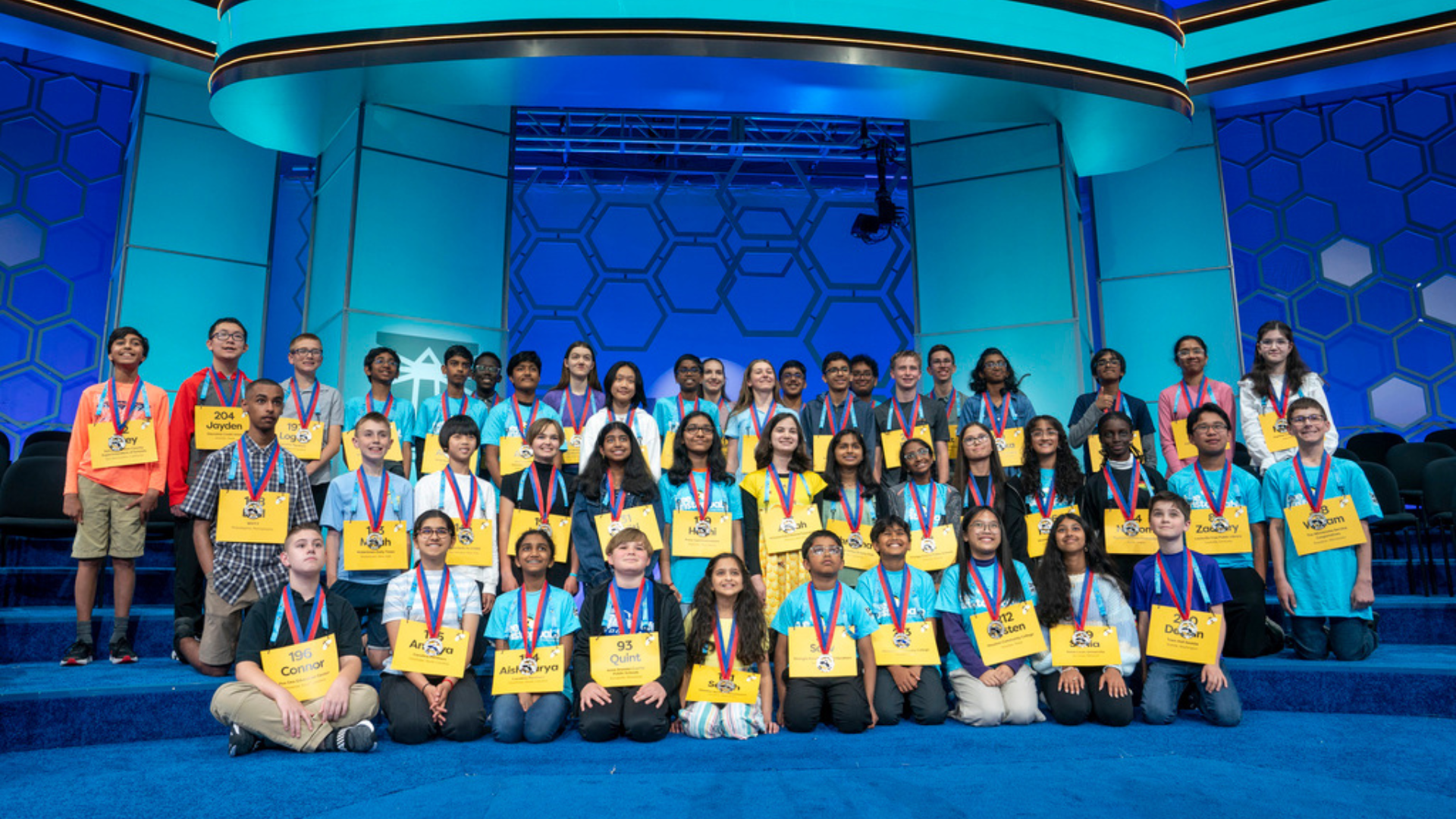 Spellers who advanced to the semifinal round pose with their medals in the Scripps National Spelling Bee