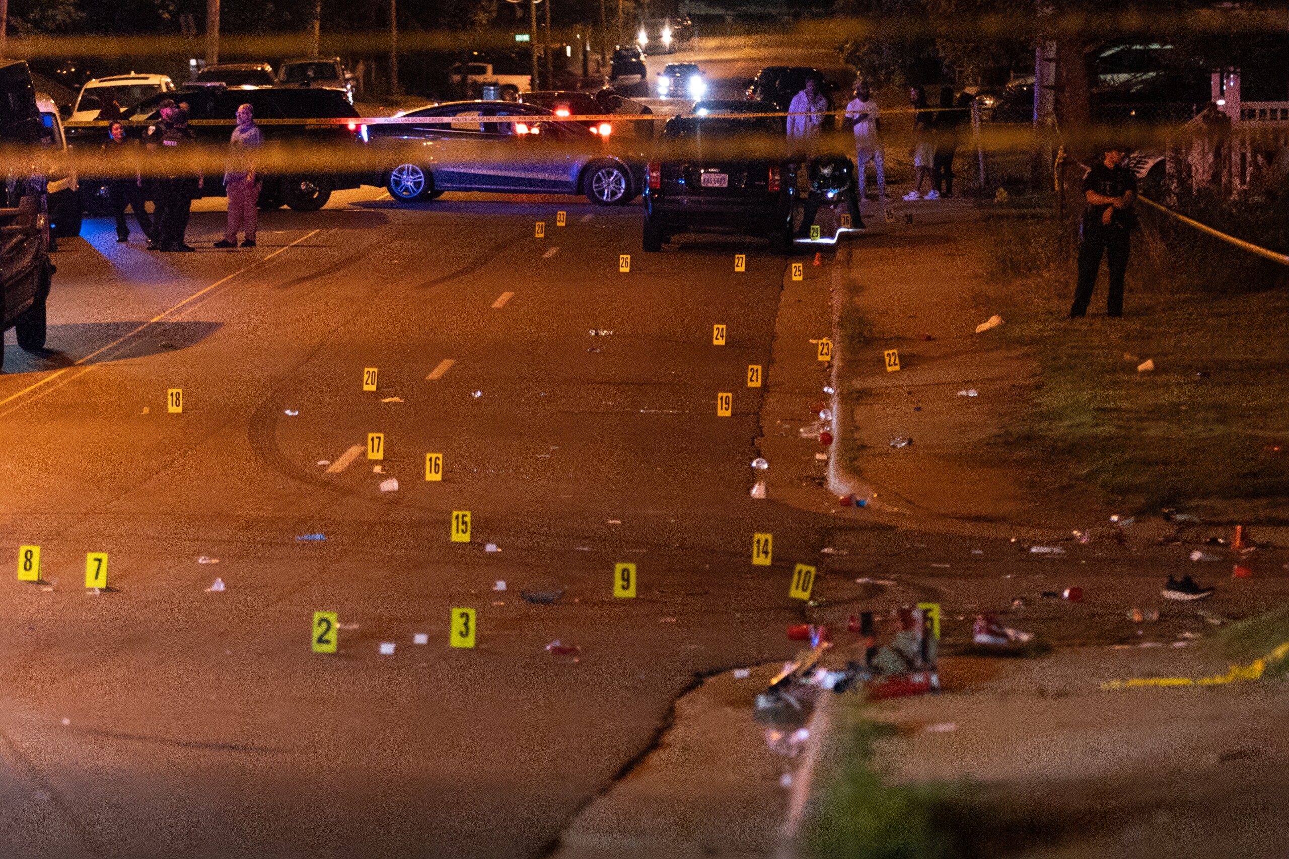 Photos show police with at least 38 evidence markers on the ground at the scene of the shooting in Akron, Ohio.