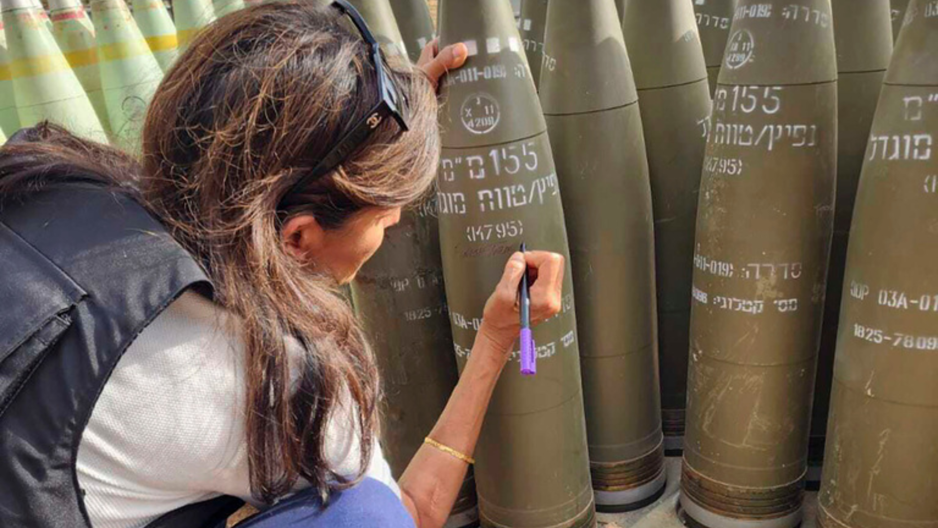 Former U.S Ambassador to the United Nations Nikki Haley signs an Israeli artillery shell.