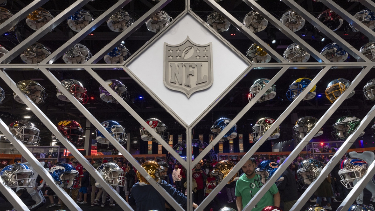 Display of football helmets representing all 32 NFL teams.