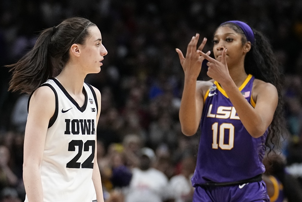 LSU's Angel Reese reacts in front of Iowa's Caitlin Clark.