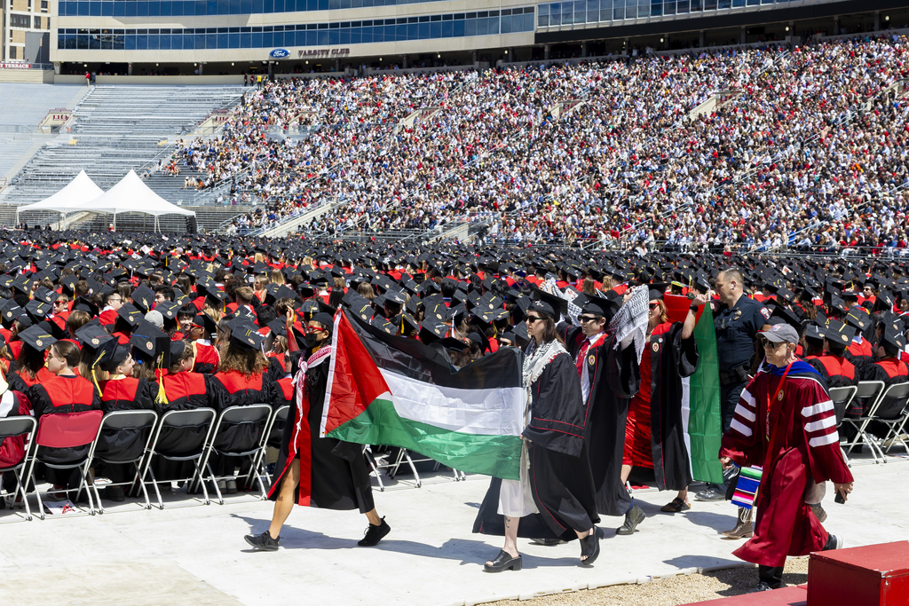 Palestinian demonstrators are escorted out of the UW-Madison Commencement.