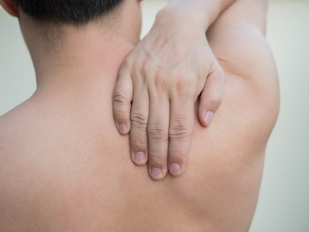 Man rubbing his shoulder.