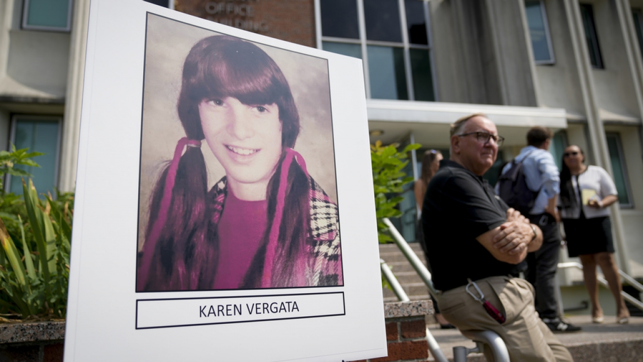 Authorities stand next to a picture of Karen Vergata.