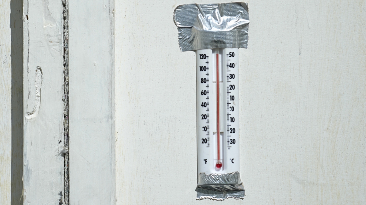 A thermometer hangs in a make-shift prison cell.